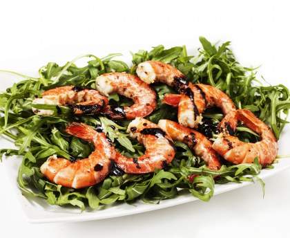Brochette de gambas sur lit de roquette